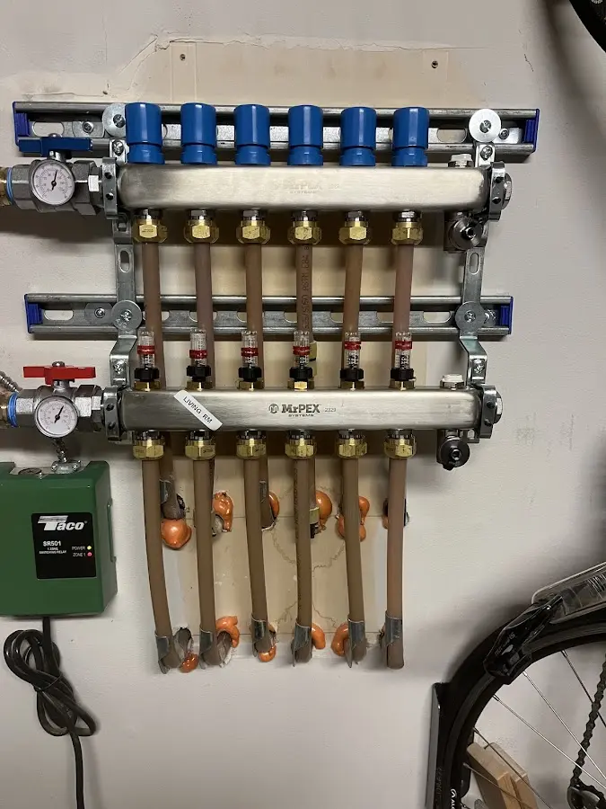 Plumber performing Water Heater Repair at a residential property in Monroe